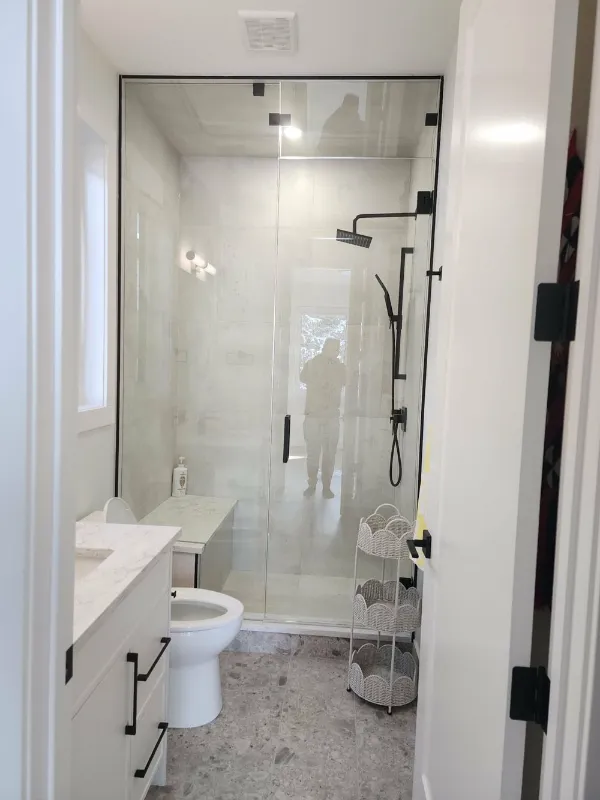 Walk-in glass shower with matte black fixtures