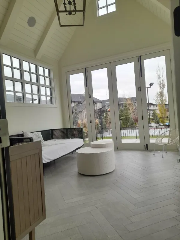 Sunroom with vaulted ceiling and French doors