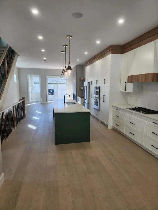 Open-concept main floor with green kitchen island