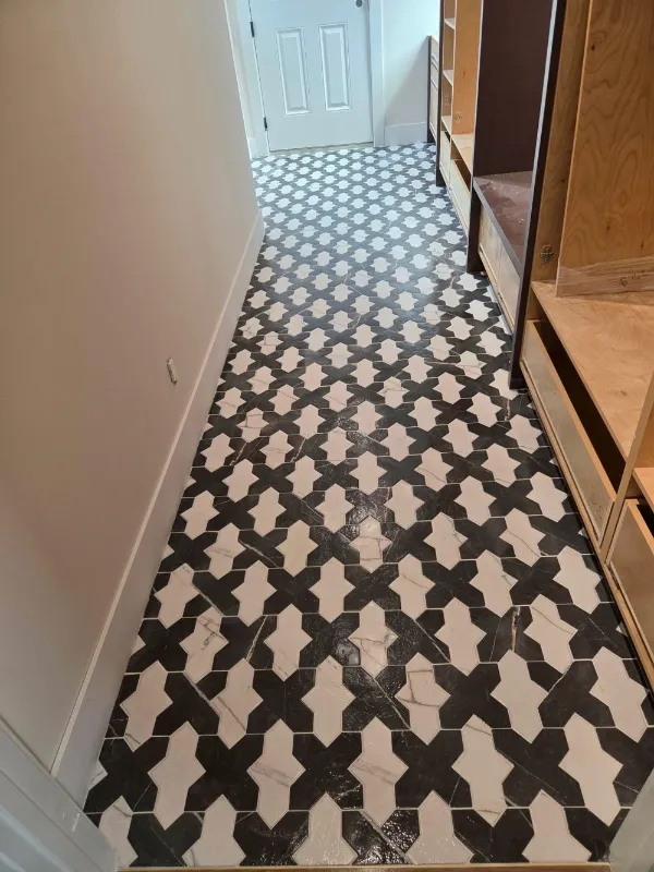 Hallway with black and white patterned floor tile