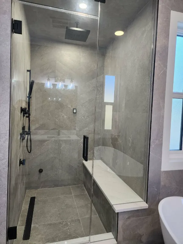 Glass shower with built-in bench and rainfall shower head