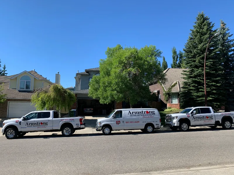 Armstrong Home Renovations trucks parked outside a Calgary home