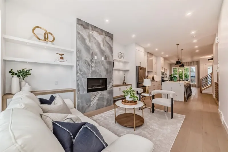 Bright renovated living room with white sofa and built-in shelving